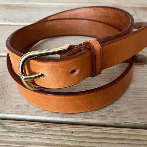 Tan leather with brass buckle.